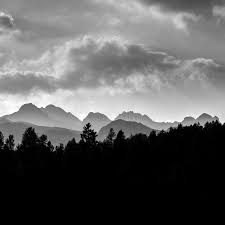 Greyscale mountain scenery with a mostly black colored landscape.
